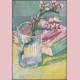 Flowering almond branch in a glass with a book